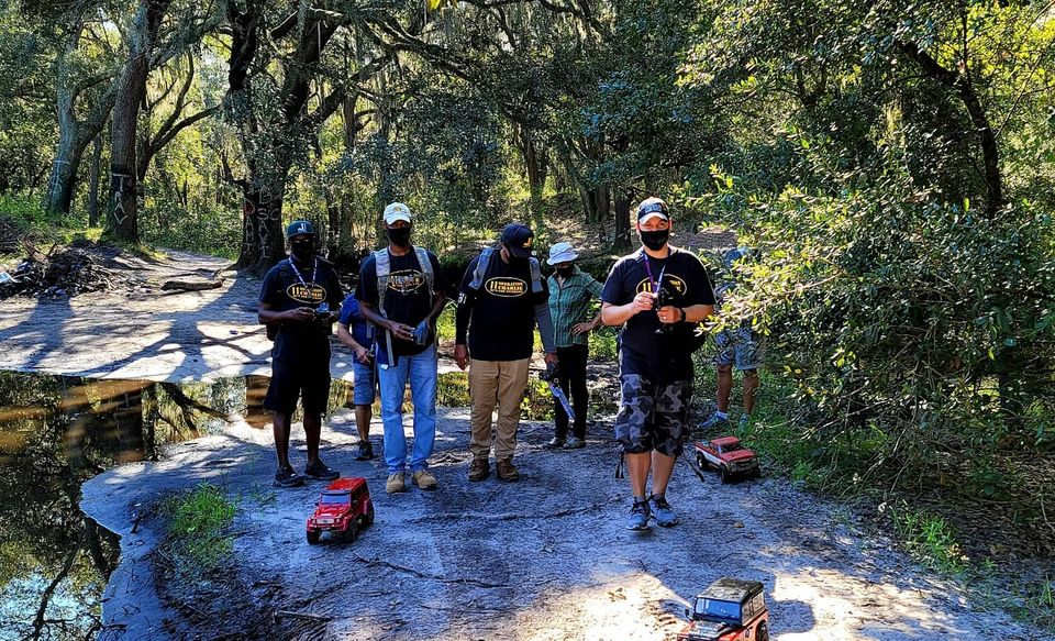 O11C members with their RC crawlers on a wooded rock trail